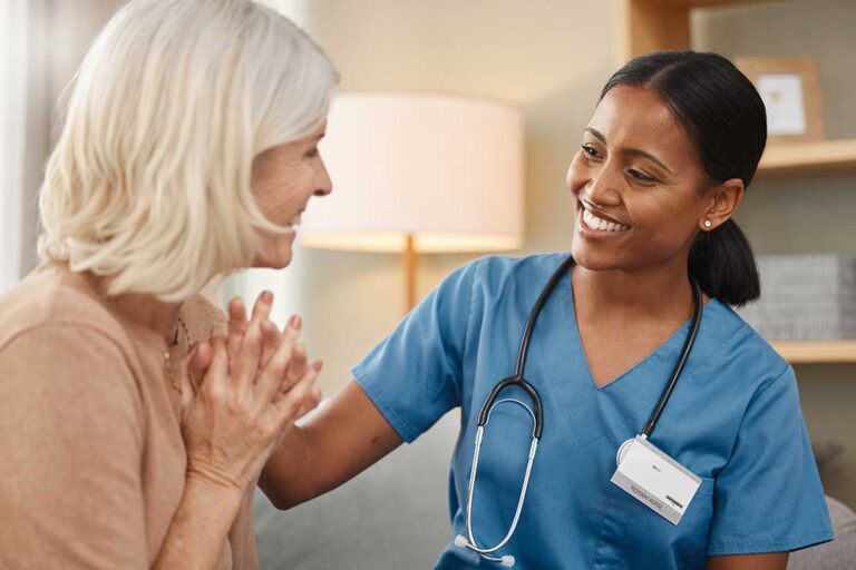 Older adult and family member reviewing care options together in a bright residential common room.